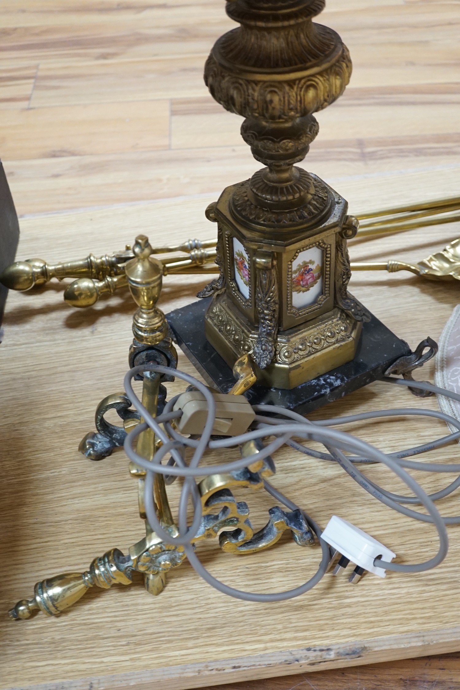 A brass table lamp and various fire implements